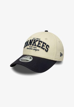 Cappellino New Era beige e nero con la scritta "YANKEES" ricamata davanti, "EST. 1903" sopra e testo American League sotto.