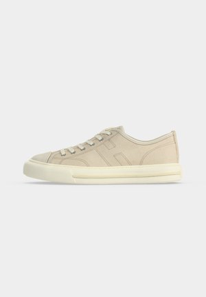 Beige low-top canvas sneaker with lace-up front and cream rubber sole, shown from left side on white background.