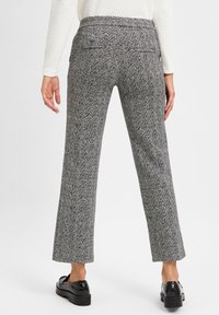 Grijze houndstooth patroon broek met een rechte pijp, middelhoge tailleband en achterzakken. Draagt het met zwarte platform schoenen.
