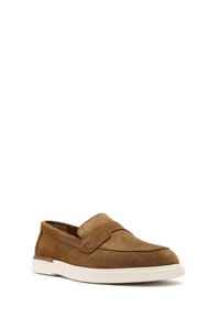 Brown suede loafers with a slip-on design, white rubber sole, and subtle stitching details on the upper, featuring a wide strap across the forefoot.
