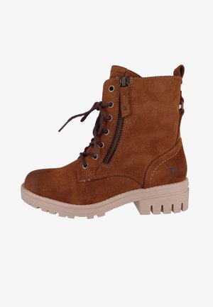 Brown suede ankle boot with lace-up and zipper closure, beige rubber sole, and stitched accents. Features a logo detail on the side.