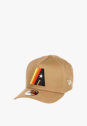 Khaki baseball cap with an embroidered black, red, and yellow letter "A" design, featuring a star and flat visor with a shiny logo sticker.