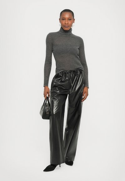 Gray striped turtleneck sweater, black glossy faux leather pants with elastic waistband, and a small black handbag.