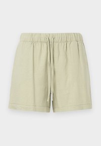 Shorts en lin vert clair avec une taille élastique et un cordon de serrage. Présente une coupe décontractée et des coutures contrastées à l'ourlet.