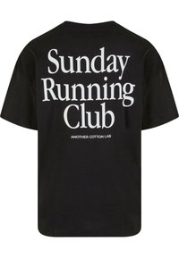 Black cotton t-shirt featuring large white text on the back that reads "Sunday Running Club" and "ANOTHER COTTON LAB" underneath.