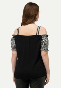 Schwarzes Off-Shoulder-Top mit Puffärmeln im Leopardenmuster und gewellten Trägern. Glattes Material, lockere Passform und abgerundeter Saum hinten.