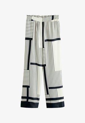 Pantalon à jambes larges et taille haute, avec des rayures noires verticales et horizontales sur fond blanc.