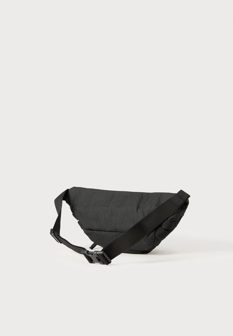 Black curved sling bag made of textured fabric, featuring an adjustable strap and a plastic buckle. Compact design suitable for casual use.