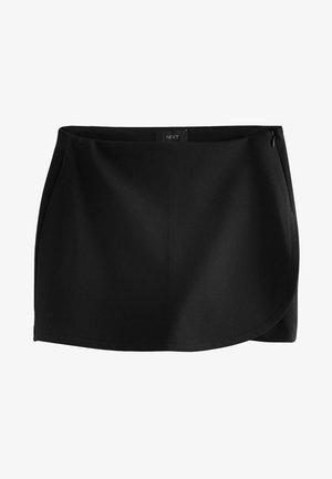 Musta käärihame, joka on valmistettu sileästä kankaasta. Siinä on sivuvetoketju ja kaareva helma, jotka tarjoavat upean istuvuuden. Yksinkertainen muotoilu ilman näkyviä kuvioita.