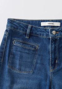 Donkerblauwe denim jeans met een rechte pasvorm, voorzien van een metalen knoopsluiting, vijf riemlussen en een enkele achterzak met stikseldetail.