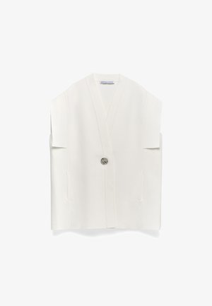 White sleeveless vest with a V-neck, two side pockets, and a single button closure. Made of smooth, textured fabric.