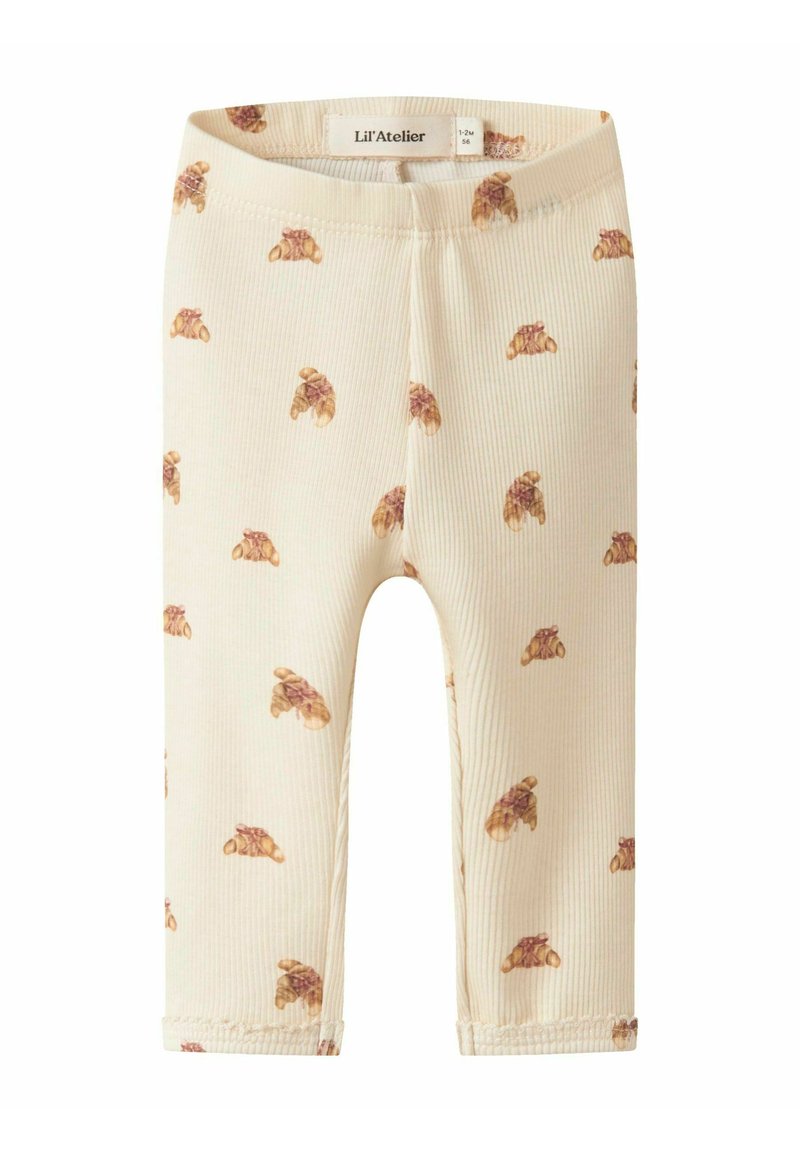 Geribbelde, roomkleurige leggings met een patroon van bruine croissants. Een elastische tailleband en afgewerkte manchetten maken het ontwerp compleet.