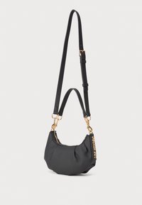 Small black handbag with gold zipper and hardware, featuring two black straps—one short and one adjustable long—and a "LOVE MOSCHINO" tag.
