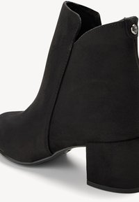 Black suede ankle boot with a mid-block heel, featuring a sleek design and smooth texture, with a subtle logo accent near the heel.