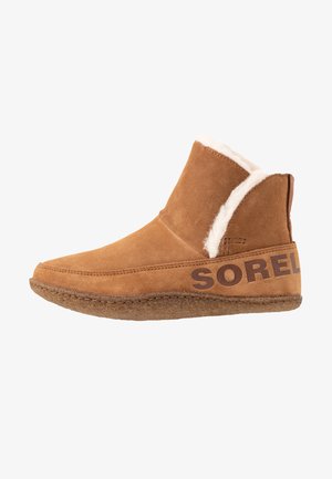 Brown suede ankle boot with white faux fur lining and brown printed branding. Smooth texture with a rounded toe and stitched detailing.