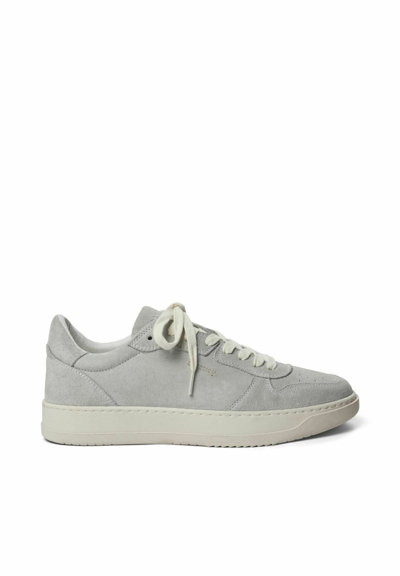 Hellgraue Wildleder-Sneaker mit gepolstertem Kragen, flachen Schnürsenkeln und einer strukturierten Gummisohle. Prägung des Markenlogos an der Seite.