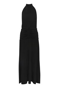 Μαύρο φόρεμα με λαιμόκοψη χελώνας, με εφαρμοστό κορσέ και ραμμένο ύφασμα γύρω από τη μέση, ρέει σε μια χαλαρή φούστα που φτάνει έως τους αστραγάλους.