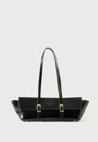 Black rectangular leather handbag with long double straps and gold buckle details on a plain light background.
