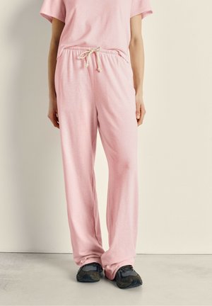 Lichtroze katoenen broek van een katoenmix met een elastische tailleband en een koord. Losse pasvorm met een zachte textuur en wijde pijpen. Gemaakt in combinatie met donkere schoenen.