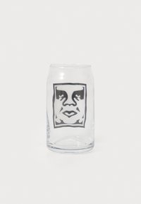 Clear glass drinking glass with slightly curved edges, featuring a black and white graphic design of a face within a rectangular border.