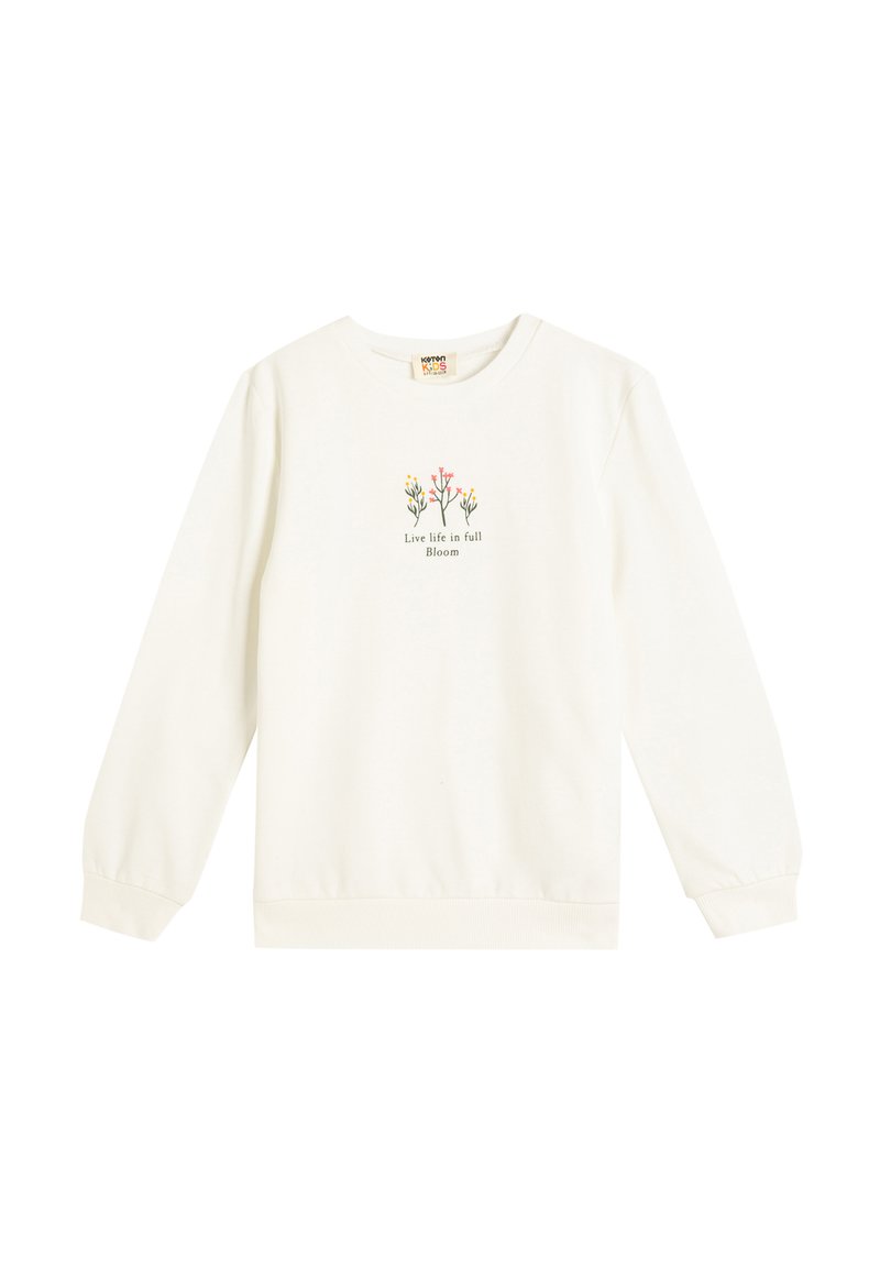 Ljus krämfärgad sweatshirts med långa ärmar, ribbade mudd och fåll. I mitten av tröjan finns en grafik med färgglada blommor och texten "Lev livet i full blomning."