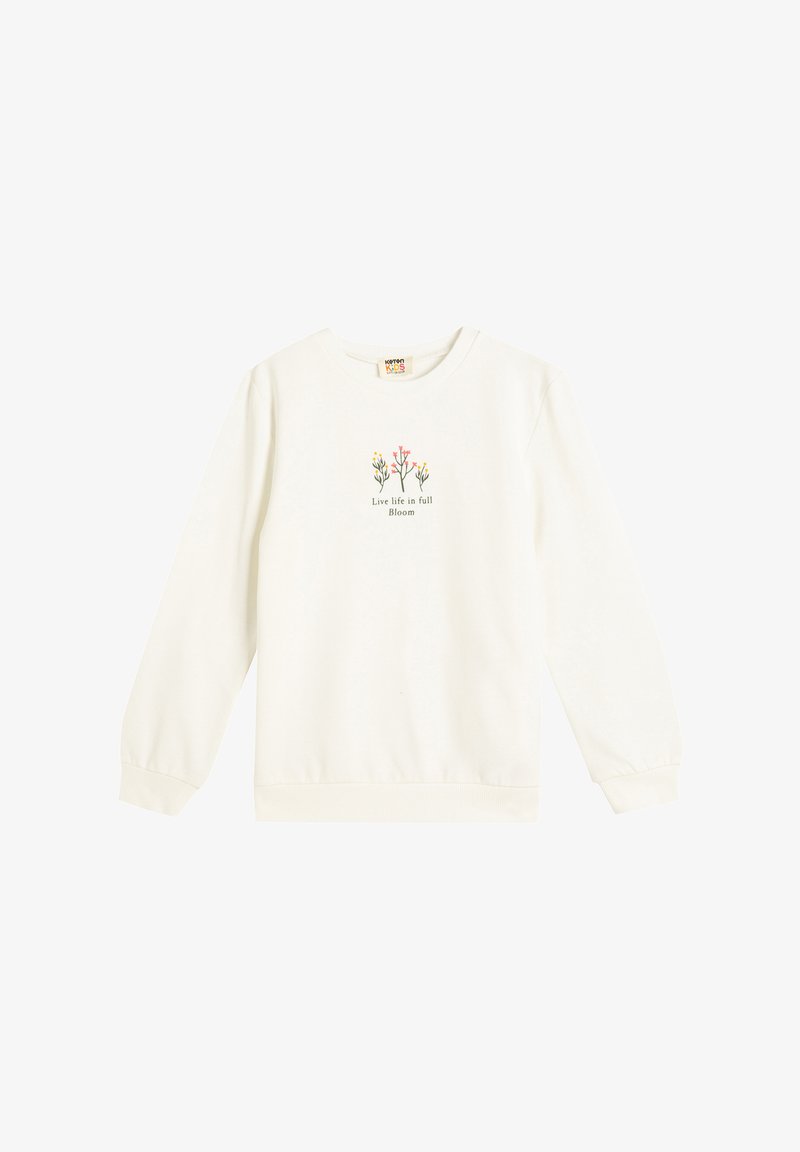 Jasna kremowa bluza z długimi rękawami, ściągaczami przy mankietach i u dołu. Centralny grafik przedstawia kolorowe kwiaty z napisem "Żyj życiem w pełnym rozkwicie."