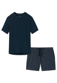 Marineblauwe katoen T-shirt met korte mouwen en ronde hals, gecombineerd met marineblauwe zwembroek met een wit stippenpatroon en een trekkoord in de taille.