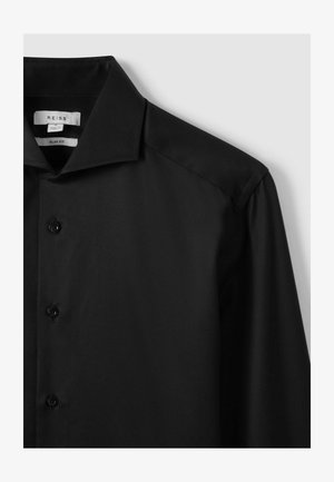 Camicia nera slim-fit con un design elegante, texture liscia, chiusura a bottoni e colletto strutturato. Etichette visibili all'interno del colletto.