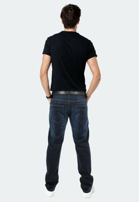 Men's dark blue denim jeans with a straight-leg fit, featuring five pockets and contrasting stitching, paired with a black short-sleeve t-shirt.