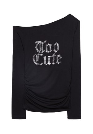 Čierna dlhá košeľa s oficiálnym dizajnom. Obsahuje riasený bočný detail a strieborné kamienkové písmená, ktoré píšu "Too Cute". Mäkkučká textúra.