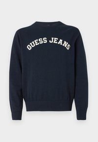 Tumszils trikotāžas džemperis ar apaļu izgriezumu un ribotu aproci, ar "GUESS JEANS" izšuvumu krēmkrāsā uz krūtīm.