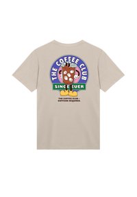Beige cotton t-shirt featuring a colorful graphic of a drink with ice and text, "THE COFFEE CLUB SINCE EVER," on the back.