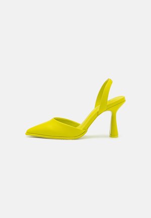 Yellow pointed-toe slingback heels made of smooth material, featuring a thin, cylindrical heel and a minimalistic design.