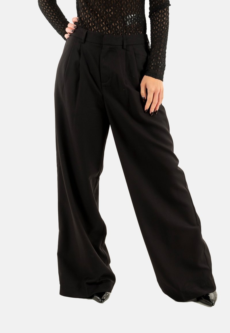 Pantaloni neri a gamba larga con vita alta, caratterizzati da una texture liscia e dettagli plissettati sul davanti. Realizzati in un tessuto leggero.