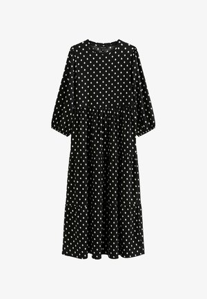 Zwarte jurk met driekwartmouwen, gelaagd ontwerp en wit diamanten patroon overal. Gemaakt van zachte stof met een ronde hals.