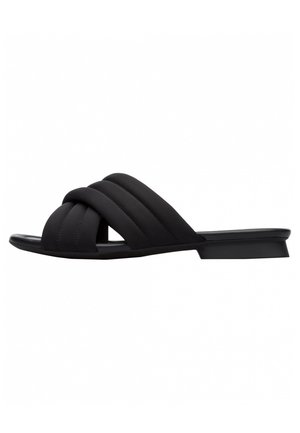 Sort flad slip-in sandal med tykke polstrede krydsremme og lav hæl, vist i profil mod en hvid baggrund.