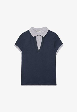 Short-sleeve navy blue polo shirt layered over a light gray collared shirt with visible buttons and cuffs.