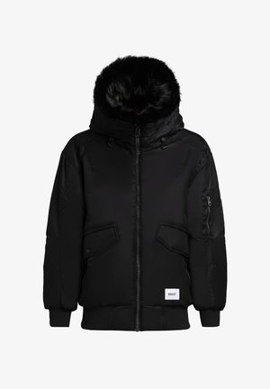 Musta puffatakki, jossa on keinoturkilla vuorattu huppu, vetoketjulliset taskut, joustavat hihansuut ja logo-merkki helmassa. Rakenne on eristetty ja muotoiltu.