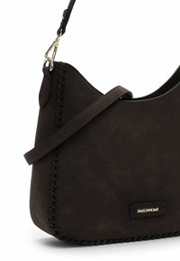 Dark brown shoulder bag made of soft suede with woven detailing along the edge and a gold-tone logo tag. Adjustable strap for convenience.