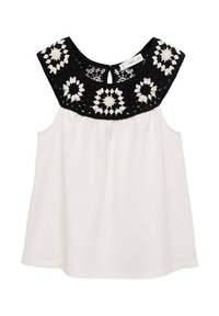 Top bianco senza maniche con un motivo floreale in pizzo nero sulla spalla. Tessuto morbido con una vestibilità rilassata e una vita arricciata.