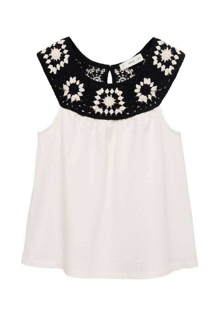 Top bianco senza maniche con un motivo floreale in pizzo nero sulla spalla. Tessuto morbido con una vestibilità rilassata e una vita arricciata.