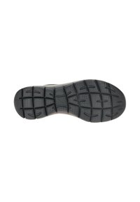 Suola di scarpa nera con profonde scanalature rettangolari e curve per una migliore trazione, esposta su uno sfondo bianco semplice.