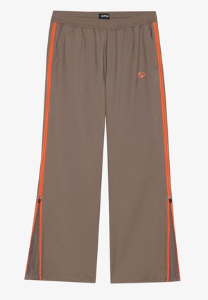 Hnědé sportovní kalhoty s oranžovými bočními pruhy, se zipovými otvory na lemu, elastickým pasem a síťovanými detaily. Hladká textura.