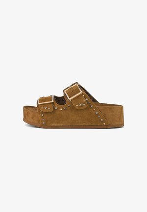 Brown suede slip-on sandal with two adjustable buckles, studded accents along the side, and a thick, textured platform sole.