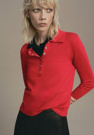 Red long-sleeve polo shirt made of smooth fabric, featuring a collar, black buttoned placket, and decorative silver buttons.