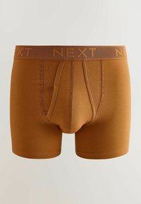 Boxers marron pour hommes avec une ceinture élastique de marque portant l'inscription « NEXT » et des coutures détaillées sur la poche avant et les côtés.