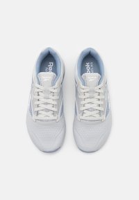 Light gray athletic shoes with a mesh upper, blue accents, and white laces. Features a textured sole and Reebok branding on the tongue.
