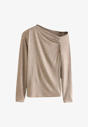 Ilga rankovė palaidinė iš minkštos, tekstūruotos smėlio spalvos medžiagos su pakelta apykakle ir surinkimo detale kairėje pusėje. Laisvas siluetas.