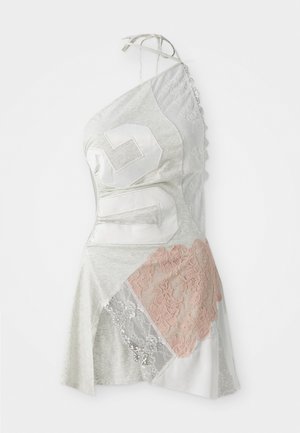 Asymmetrical dress features gray fabric with patchwork design, including white and pale pink lace accents, and a large white number 26.