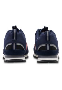 Navy blue athletic shoes with a suede and mesh upper, featuring red accents, padded collar, and black rubber outsole with white stripes.